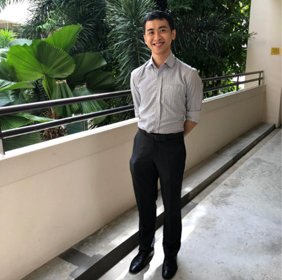 Mr Chen posing along the school corridor.